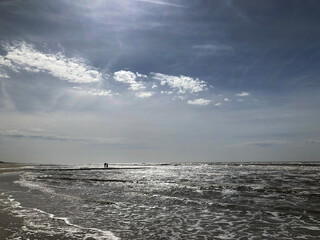 Northsea and beach. Julianadorp Noord Holland Netherlands. People on breakwater. 