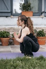 Woman in restorative yoga squat pose.