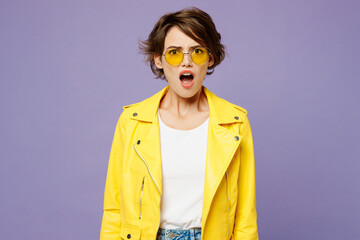 Young sad shocked woman she wears yellow shirt white t-shirt casual clothes glasses look camera with opened mouth isolated on plain pastel light purple background studio portrait. Lifestyle concept.
