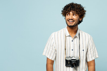 Traveler smiling amazed Indian man wear white casual clothes look aside on area isolated on plain...