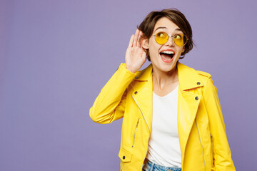 Young curious nosy woman she wears yellow shirt white t-shirt casual clothes glasses try to hear you overhear listening intently isolated on plain pastel light purple color studio. Lifestyle concept. - obrazy, fototapety, plakaty