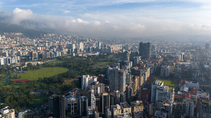 Aerial drone view of Quito capital city of Ecuador South America Parque La Carolina Sunrise early...