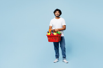 Full body young happy Indian man wear white t-shirt casual clothes hold red basket for takeaway...