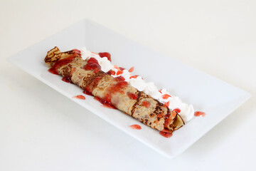 Pancakes with strawberry jam and cream. closeup
