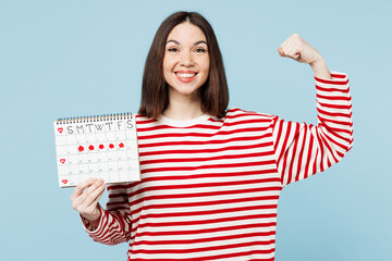 Young happy woman wear red casual clothes hold female periods pms calendar checking menstruation...