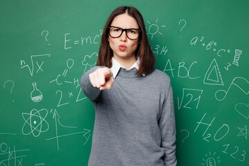 Young strict smart teacher woman wear grey casual shirt glasses pointing index finges camera on you...