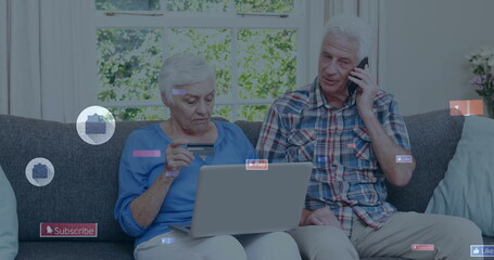 Image of social media icons over caucasian senior couple using electronic devices at home