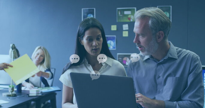 Image of social media icons and data processing over diverse business people in office - Powered by Adobe