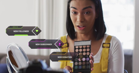 Image of social media data and icons over biracial woman on makeup vlog