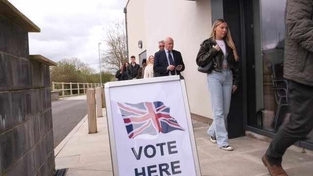 4K: Group of Voters stand in line at Polling Place for the UK General Election.  People queuing up. Stock Video Clip Footage