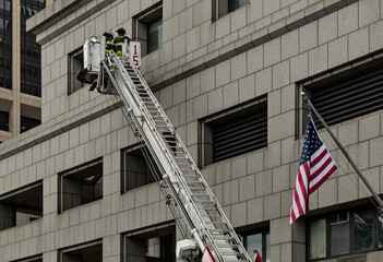 firefighters on a ladder against a building (unrecognizable, no face) FDNY new york fire fighters...