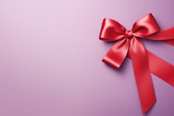 Red ribbon with bow on lavender background, Christmas card concept. Space for text. Red and Lavender Background