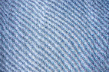 Blue denim texture, light jeans. Blue cotton canvas fabric texture as background