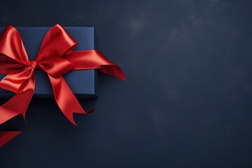 Red ribbon with bow on navy blue background, Christmas card concept. Space for text. Red and Navy Blue Background 
