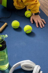 Vertical image. Woman sitting on yoga mat after warmup before strenght training