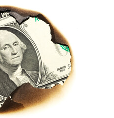burnt savings concept background. one us dollar paper in hole - 785410123