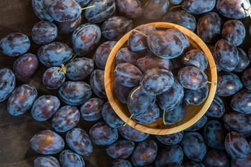 Plum variety Hungarian. Fruit harvest on the table in the kitchen. Autumn blue plum. Vitamin food bowl.