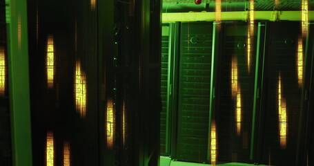 Glowing yellow lights and data processing over green lit, dark computer server room