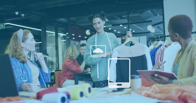 Image of application icons and graphs over diverse designer showing garment to coworkers
