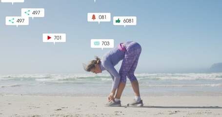 Image of social media data processing over caucasian woman in sports clothes on beach