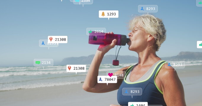 Image of social media data processing over caucasian drinking during exercis on beach - Powered by Adobe