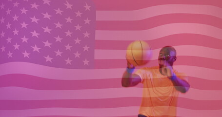 Image of flag of america over african american male basketball player jumping with ball