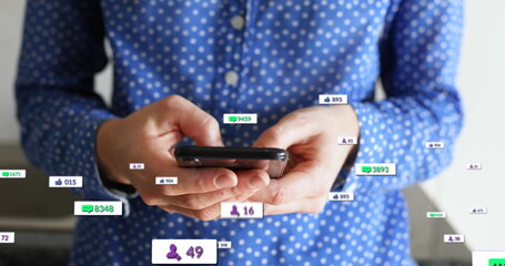 Image of social media text and icons over caucasian man with smartphone at home