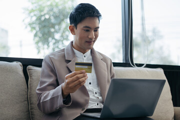 Male use computers and smartphone to pay through credit card payment channels. Online shopping.