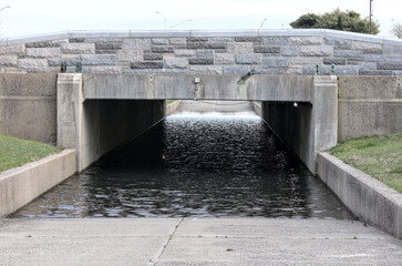 flooded tunnel passageway with standing water under roadway (jones beach access to ocean in long...