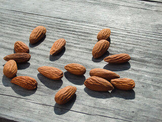 Almond nuts on grey wooden table background. Almond nuts on a wooden desk