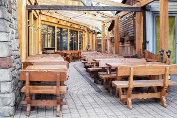 ZAKOPANE, POLAND - APRIL 05, 2024: Lots of empty seats on wooden benches, where tourists haven't...
