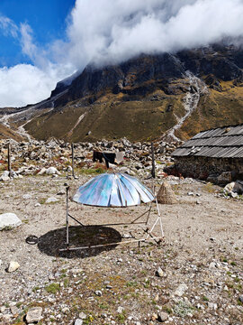 Warming the teapot in a solar cooker. Nepal. Himalaya