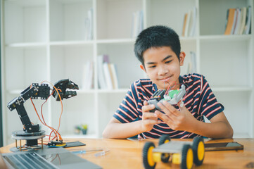 Asian boy learning and studying the work of technology robots.homeschool and science for tech...