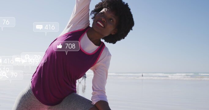 Image of social media data processing over african american woman stretching on beach - Powered by Adobe
