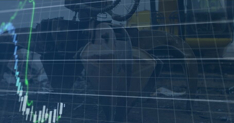 Image of financial data and graphs over machines on junkyard