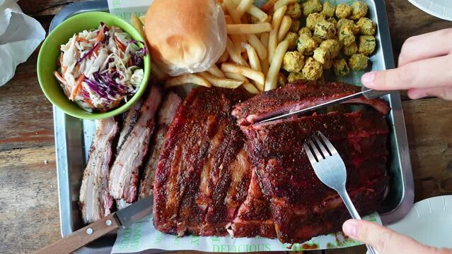 Smoked Texas bbq pork ribs and belly with coleslaw and fries top view 4k