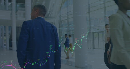 Image of financial data over caucaian businessmen walking in office