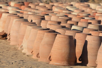 making and preparing clay pots outdoors