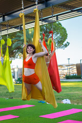 Exercises for body flexibility on suspended fabric, aerial yoga.