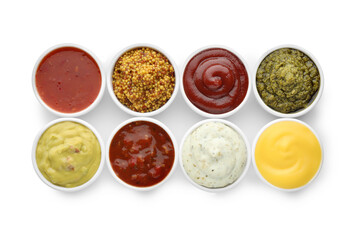 Many different sauces in bowls on white background, top view