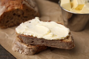 Slices of bread with tasty butter on table, closeup