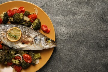 Delicious baked fish and vegetables on grey background, top view. Space for text