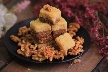 Famous Indian sweet Kalakand Made Of Khoya Doodh Malai Decorated With Badam Or Badaam garnished with Nuts Kaju And Pista closeup with selective focus and blur