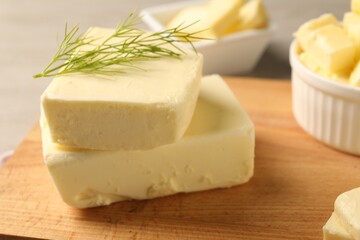 Tasty butter with dill on wooden table, closeup