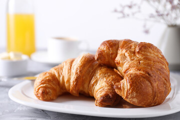 Tasty breakfast. Fresh croissants on grey table, closeup