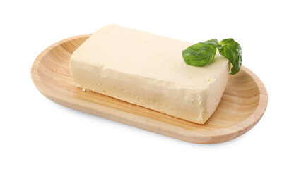 Block of tasty butter with basil isolated on white