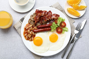 Delicious breakfast with sunny side up eggs on light table, flat lay