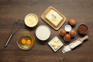 Flat lay composition with fresh butter among other products on wooden table