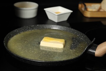 Melting butter in frying pan on cooktop