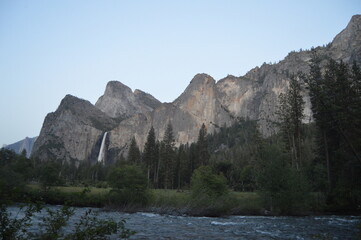Lake with mountain and trees in the background at sunset in Yosemite National Park